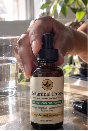 A MoringaGrowers bottle held at a table — the growers' own hands behind every order